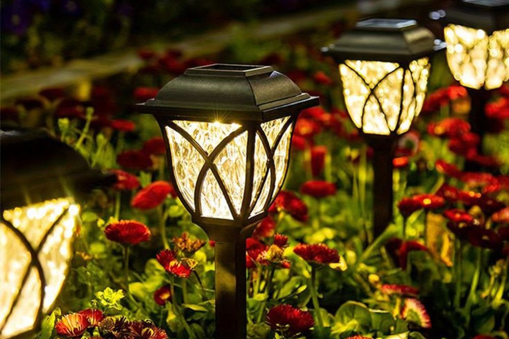 Solar garden lights illuminating a lush garden at dusk, creating a warm and inviting atmosphere.